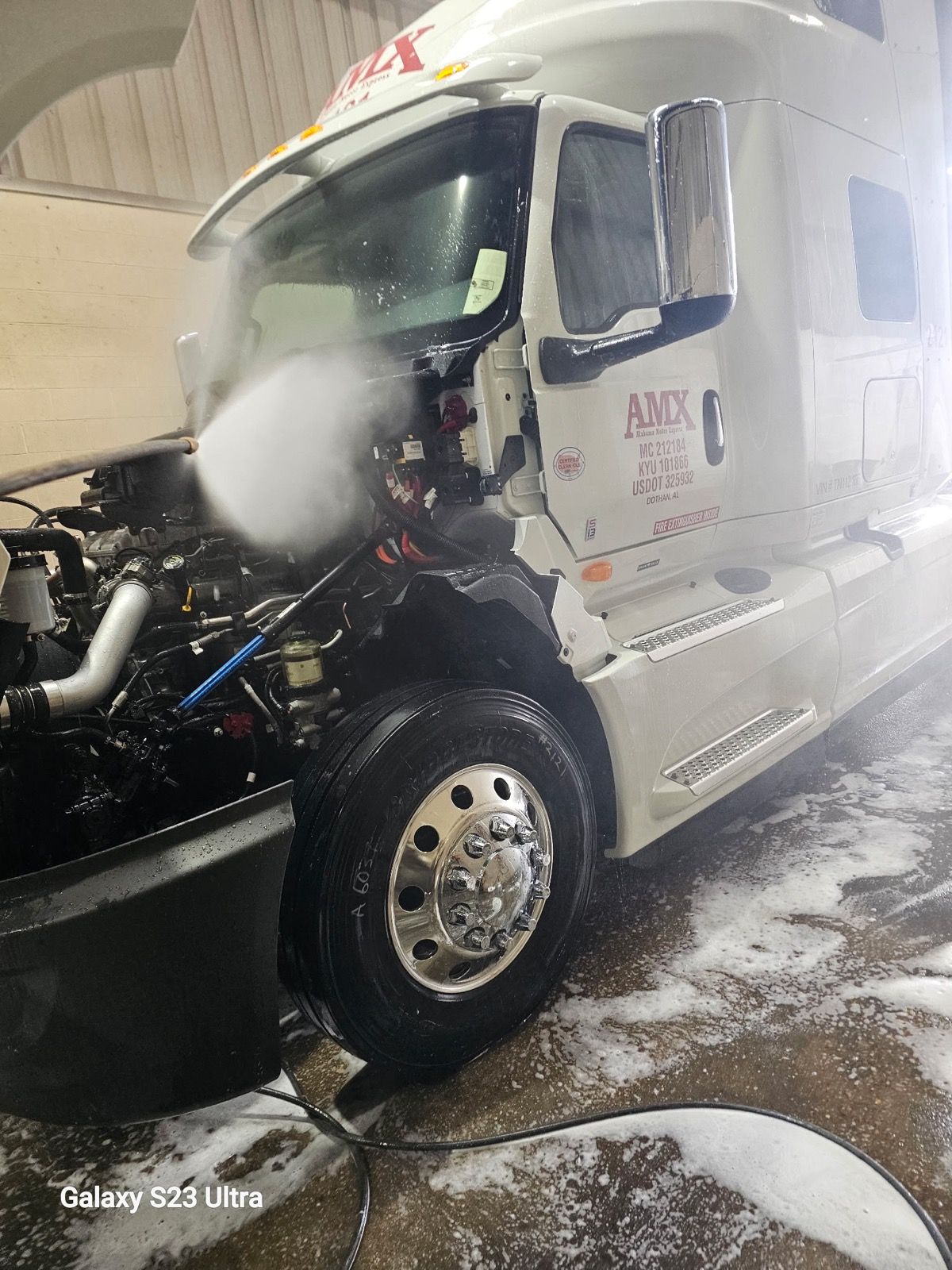 Ron washing a semi truck on site